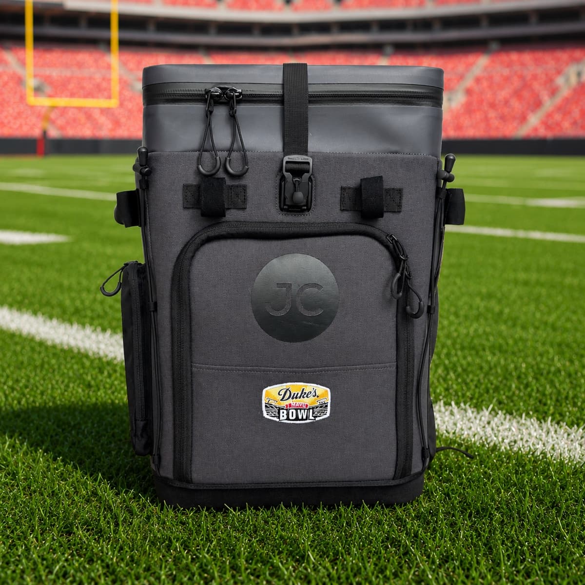 A JustinCASE bag with Duke's Mayo Bowl branding on a football field