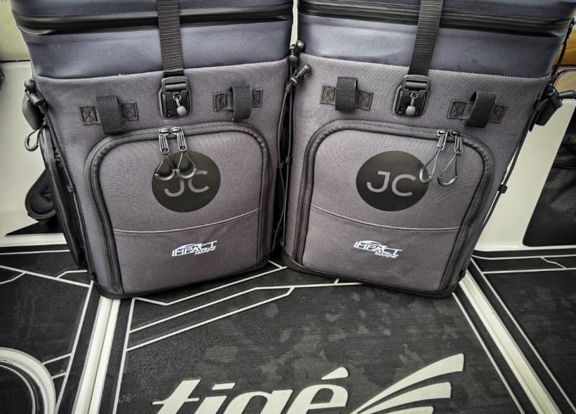 Two custom-branded JustinCASE bags on a boat deck
