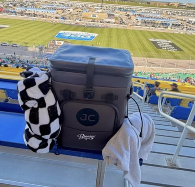 A JustinCASE bag on a grandstand seat at a racetrack