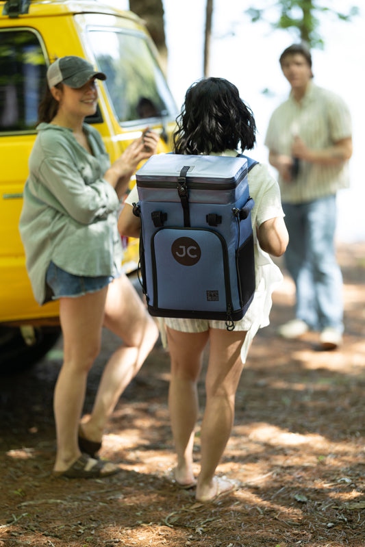 Person walking outdoors with a JC cooler backpack